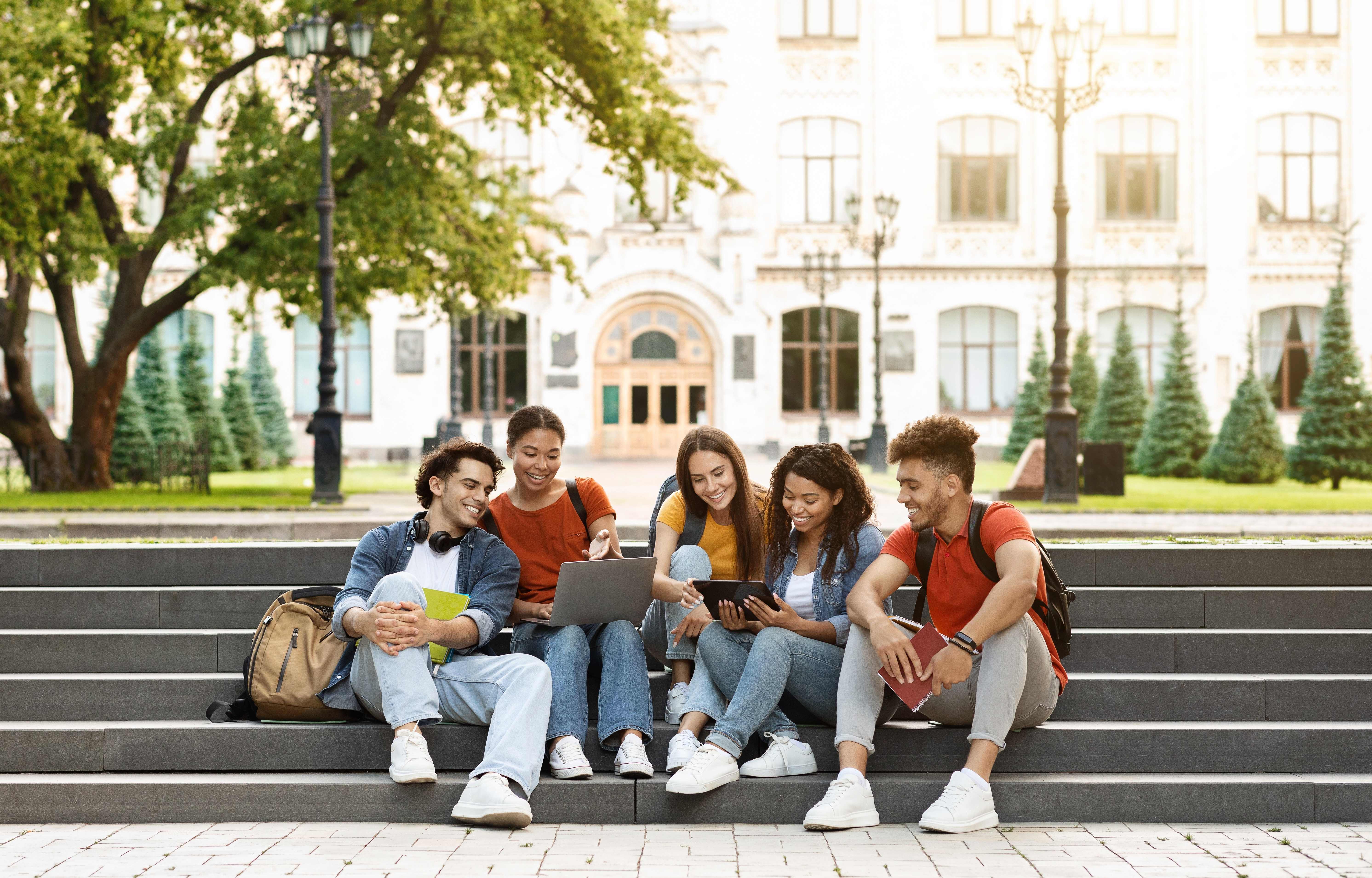 Students studying on steps outside their university building