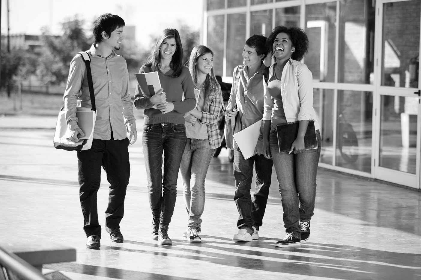 Monochrome students walking together in a supportive group