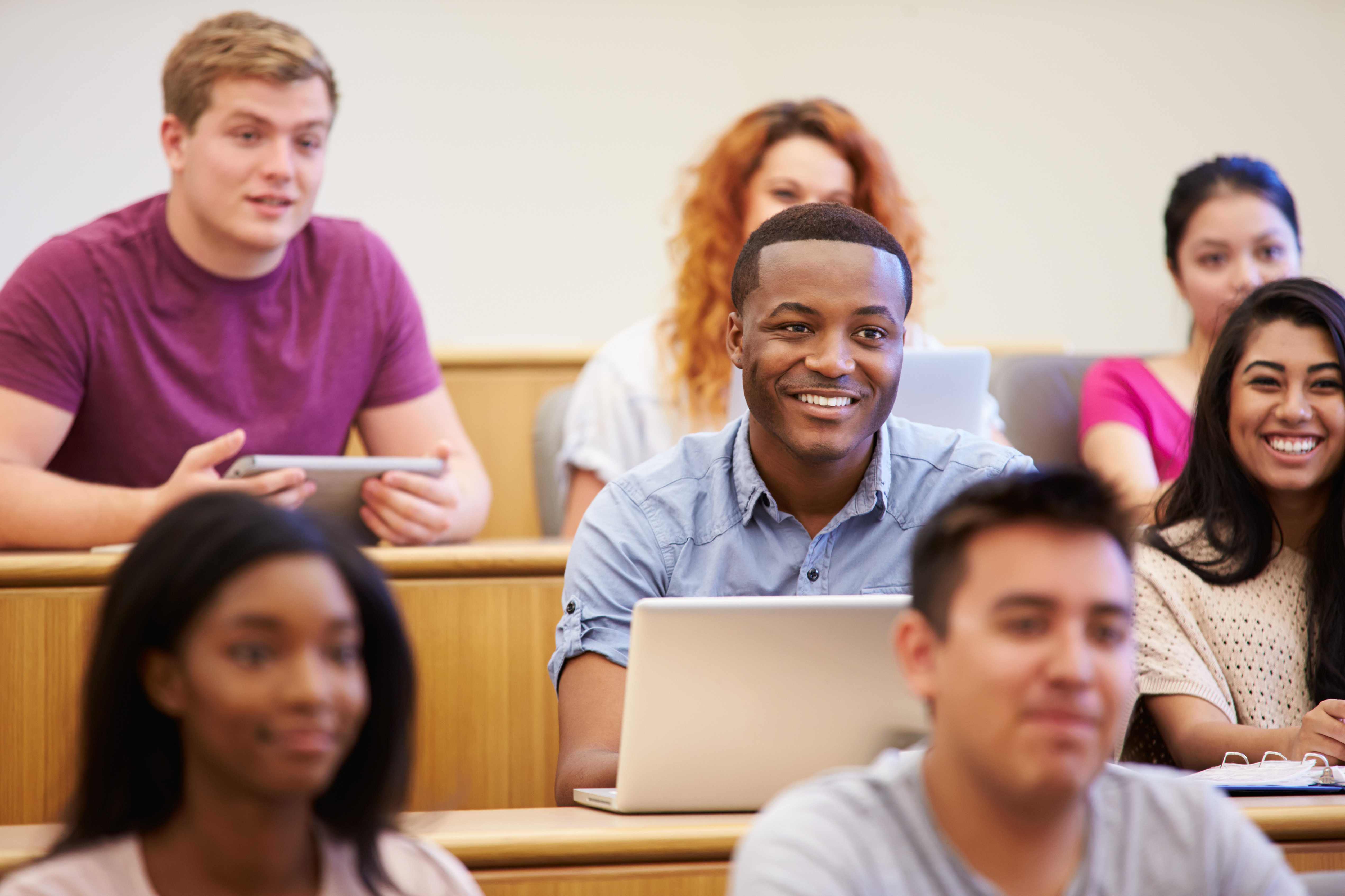 Students smiling during lecture providing ISB feedback