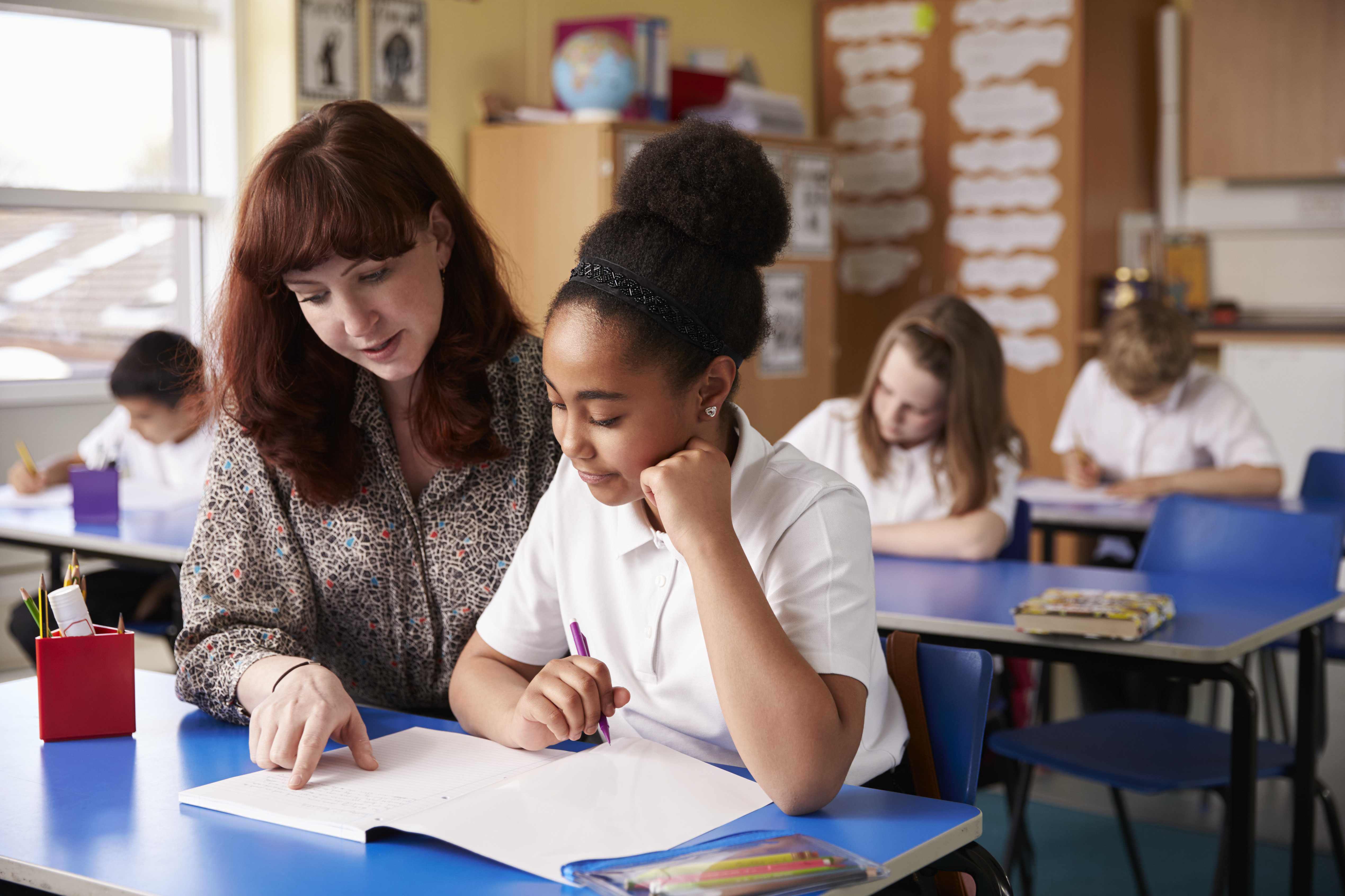 Teacher assisting student in classroom